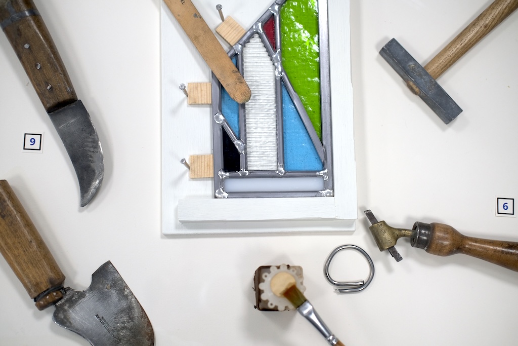 Photograph of stained glass sample and tools